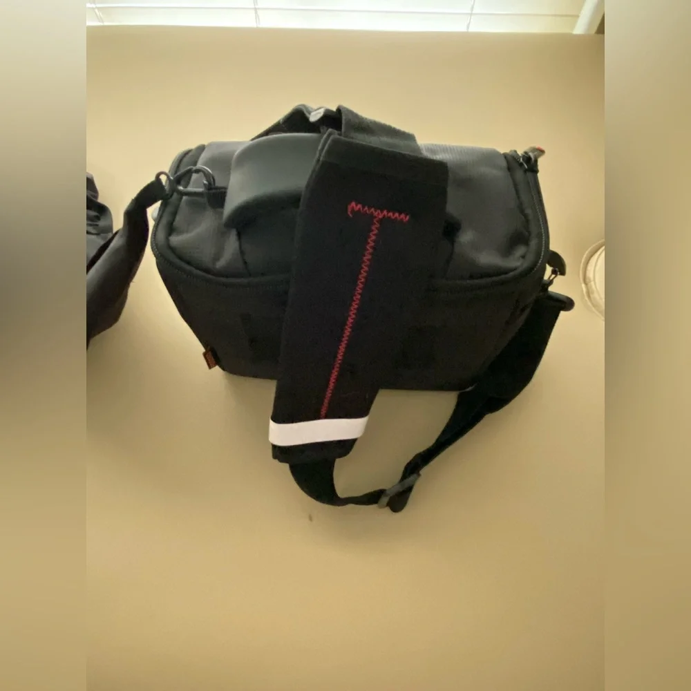 NWOT- padded camera bag w/ camera rain cover.